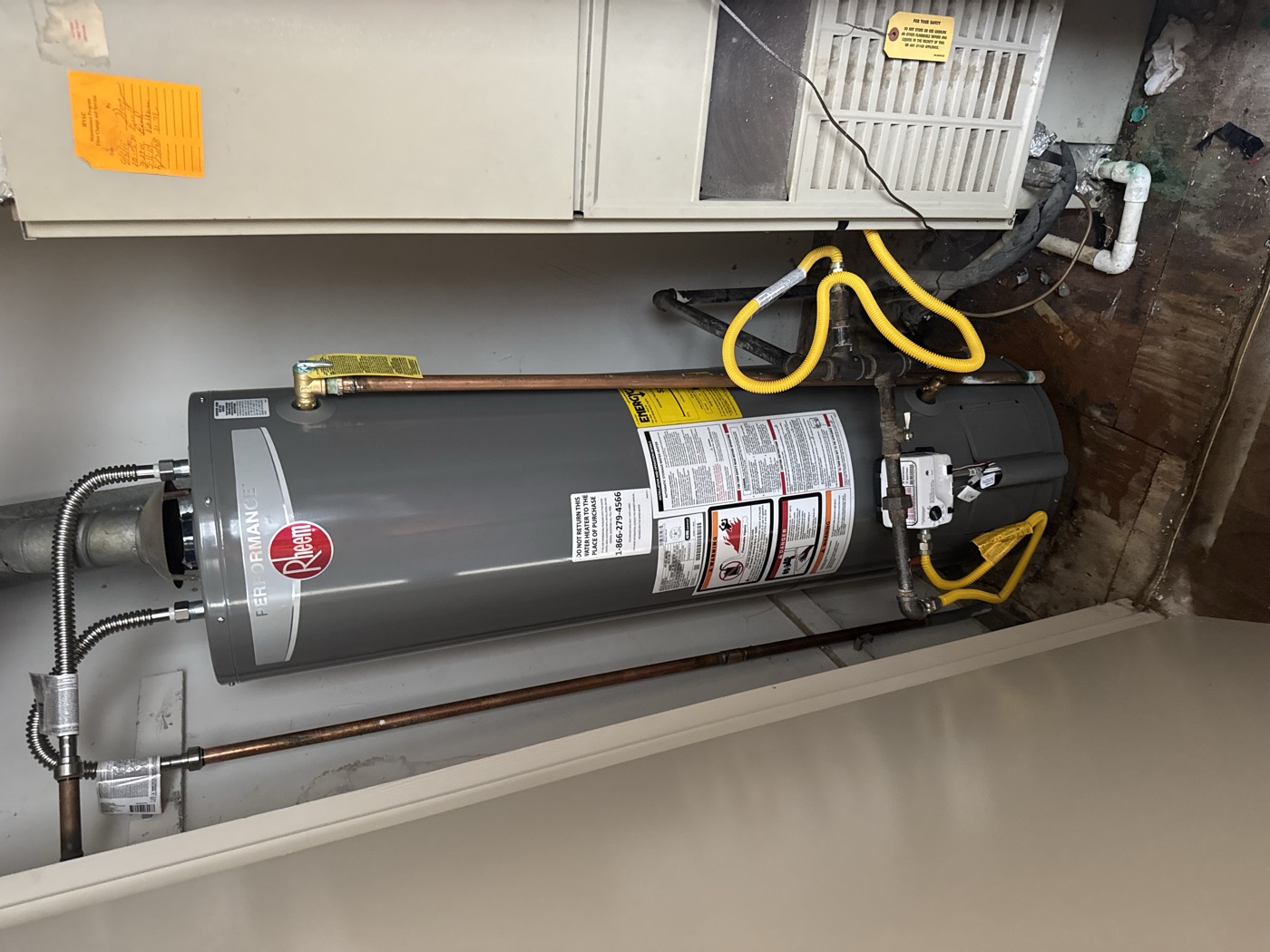 Rheem water heater and HVAC system installed side by side